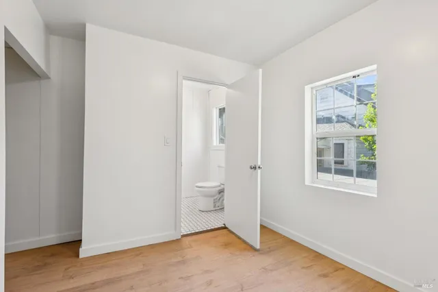 a bedroom with a bed and cabinets