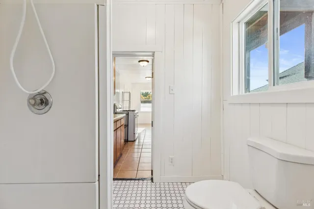 a view of a backyard with potted plants and wooden fence