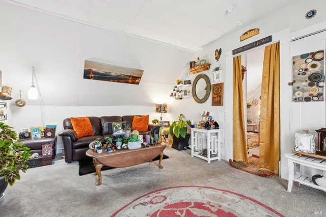 a view of a house with a yard and sitting area