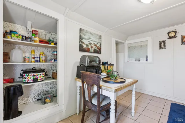 a spacious bedroom with a bed and a chandelier