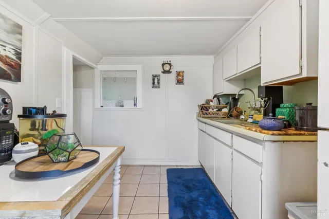 a kitchen with a stove a sink and a window