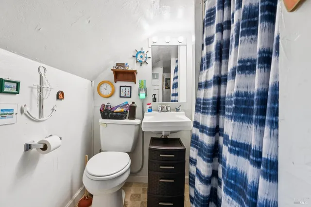 a kitchen with stainless steel appliances a table and chairs in it