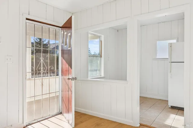 a view of a livingroom with a fireplace and wooden floor