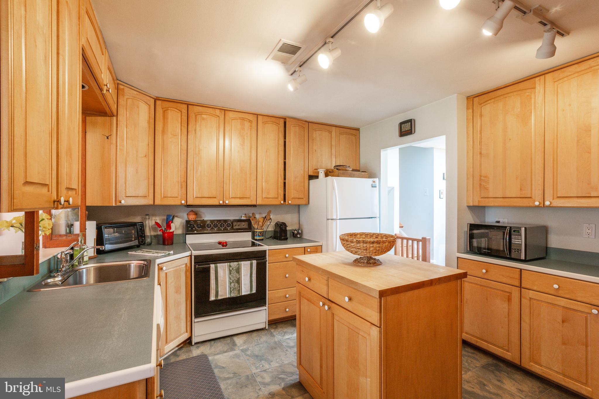 11340 Rambling Road Gaithersburg, MD 20879 - Photo 16 of 42 Kitchen with island and plenty of storage
