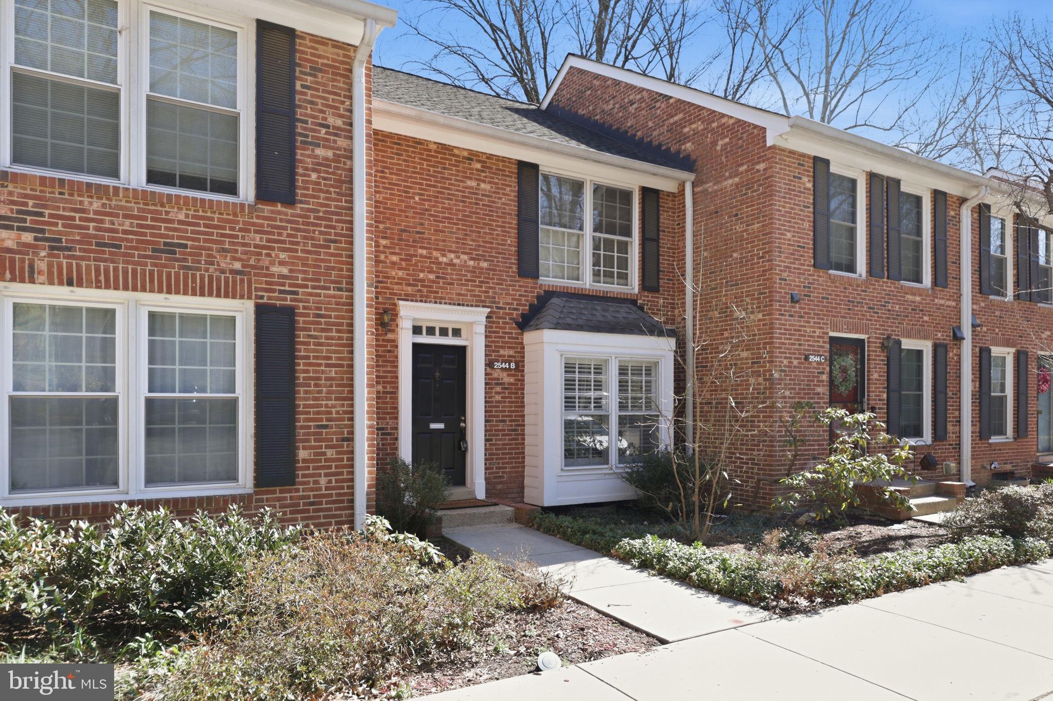 2544 South Walter Reed Drive, Unit B Arlington, VA 22206 - Photo 2 of 28 a view of a brick house with a yard and windows