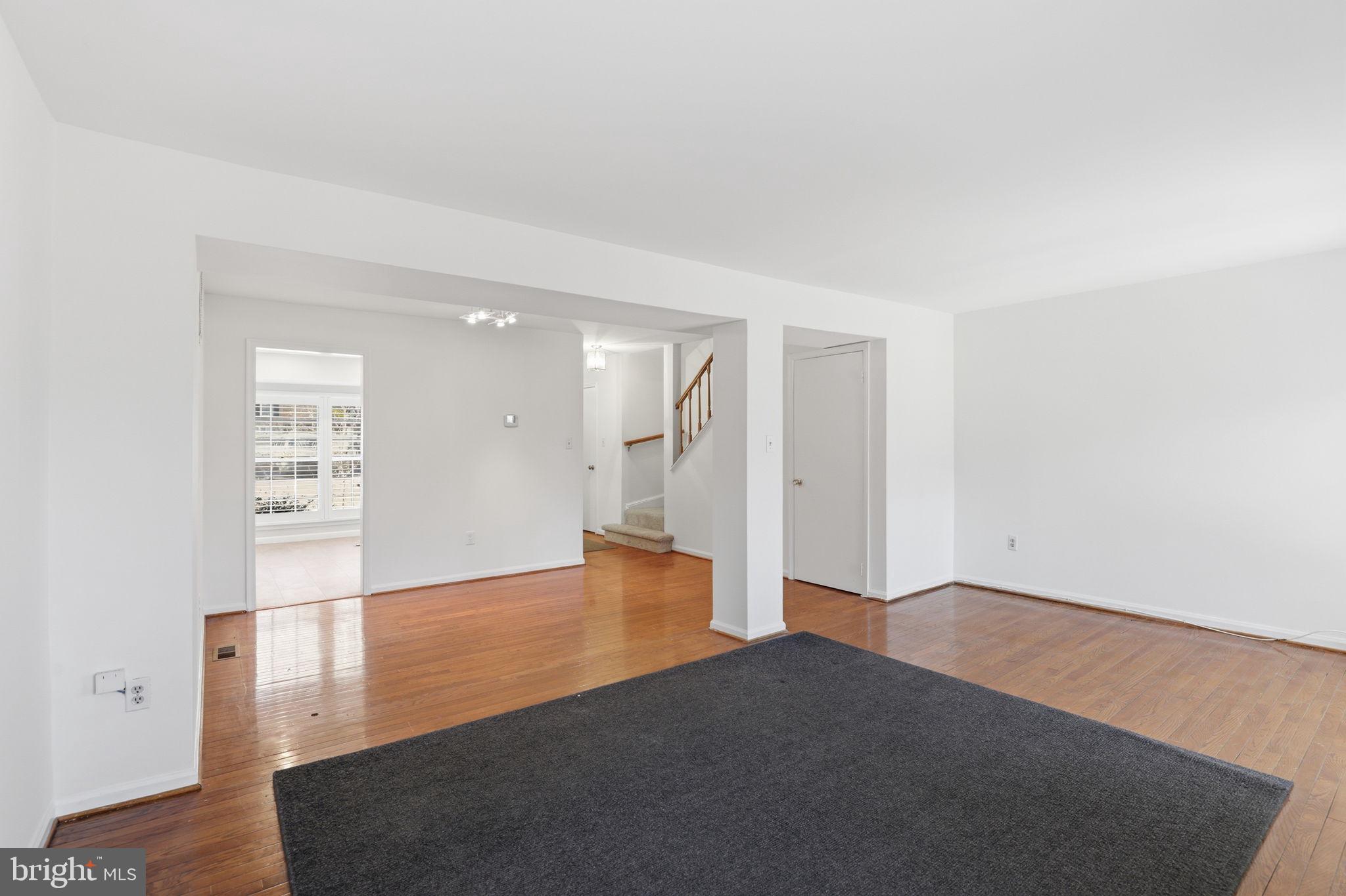 2544 South Walter Reed Drive, Unit B Arlington, VA 22206 - Photo 8 of 28 a view of an empty room with wooden floor and a cabinet
