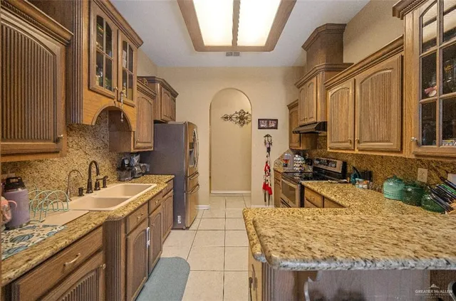 a bathroom with a granite countertop double vanity sink and a mirror