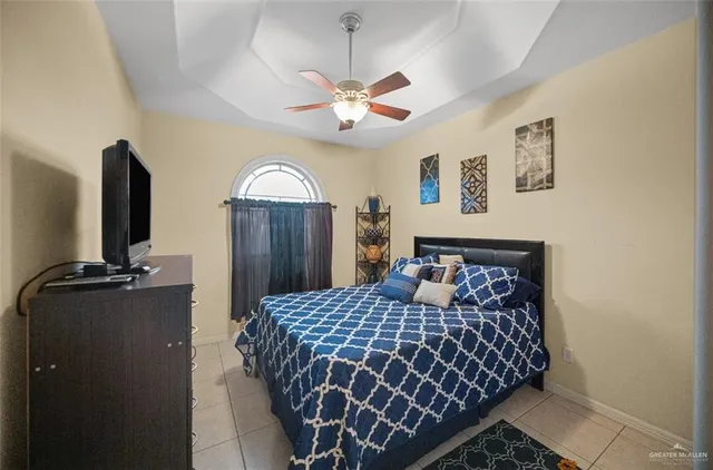 a bedroom with a bed and a chandelier