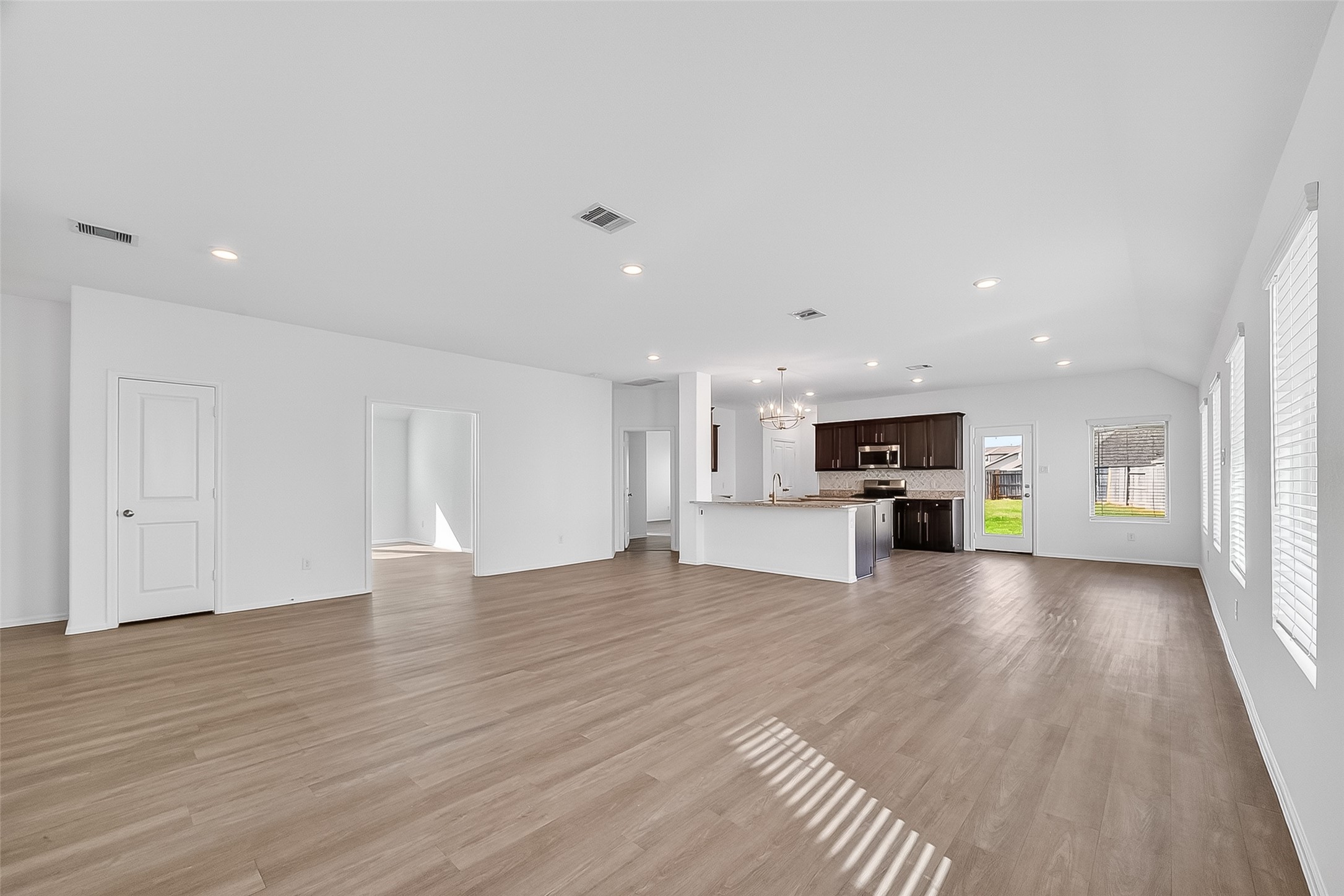 19168 Pinewood Grove Trail New Caney, TX 77357 - Photo 14 of 41 a view of kitchen with stove and wooden floor