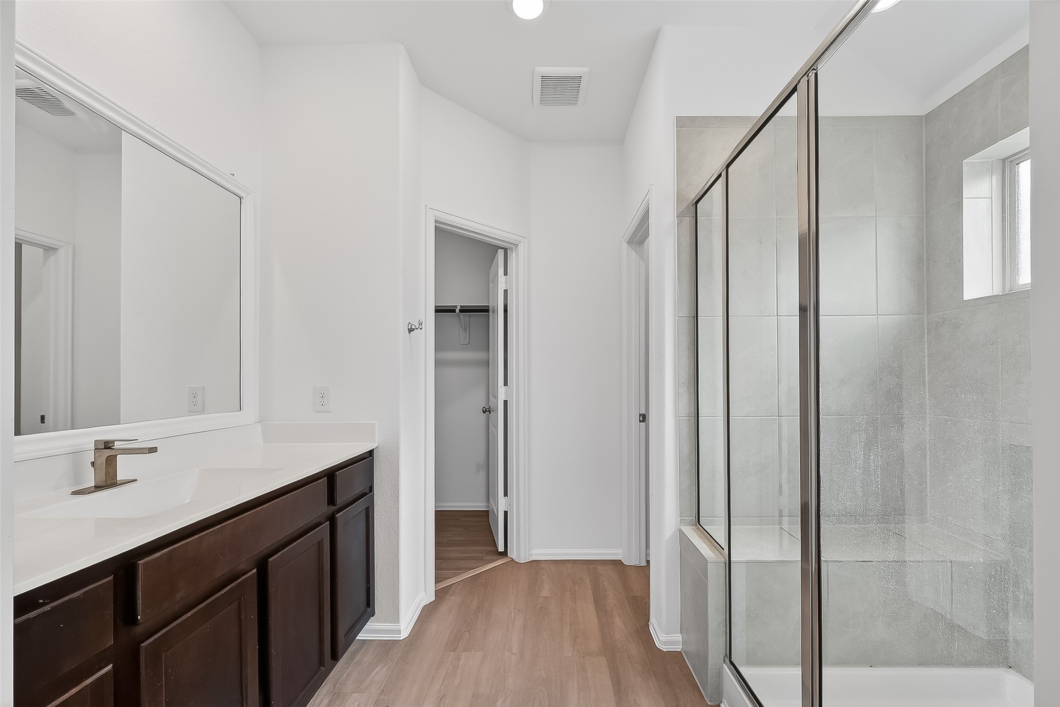 19168 Pinewood Grove Trail New Caney, TX 77357 - Photo 33 of 41 a bathroom with a sink a mirror and a shower