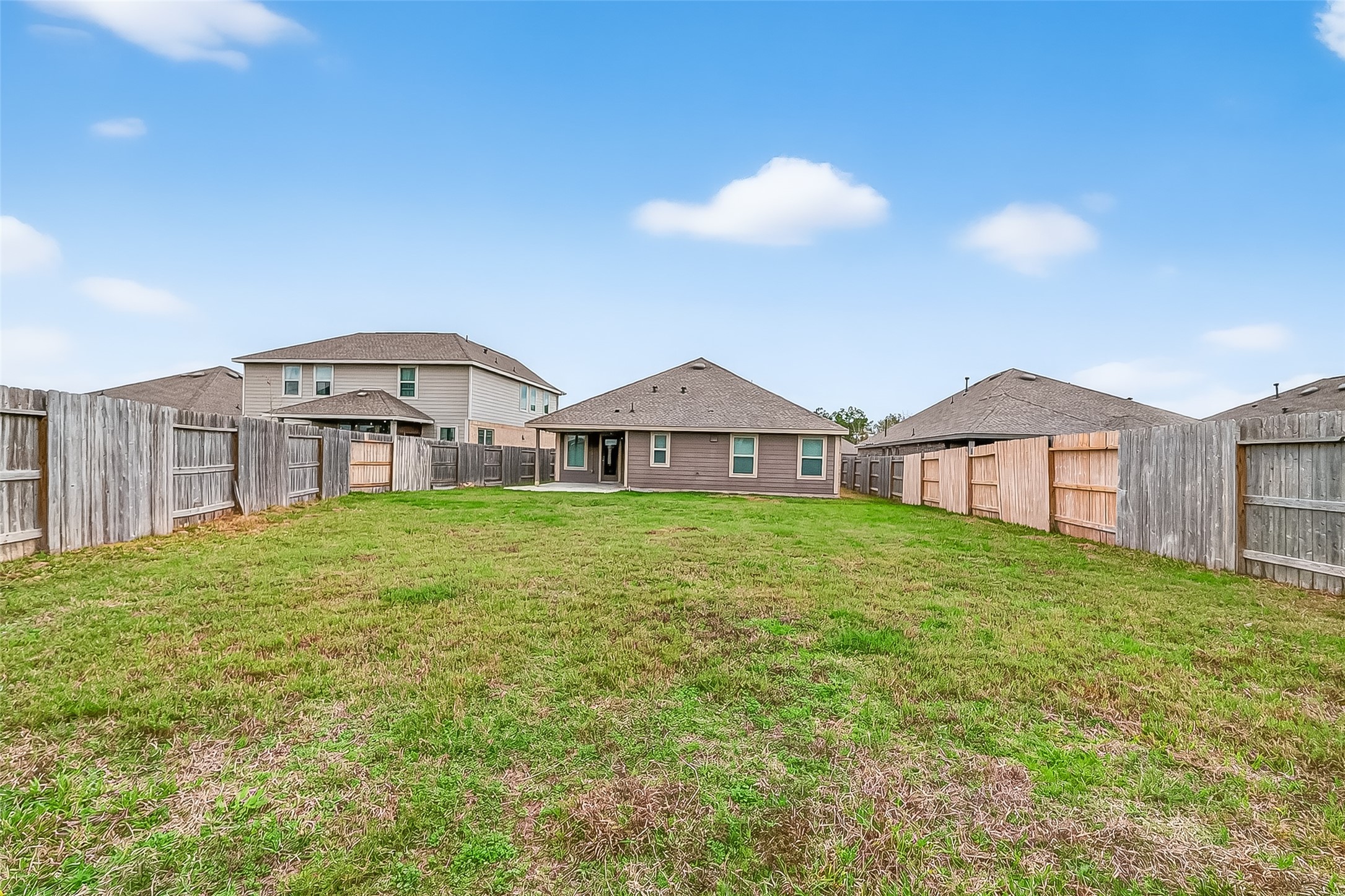 19168 Pinewood Grove Trail New Caney, TX 77357 - Photo 40 of 41 a view of a big house with a big yard and large trees