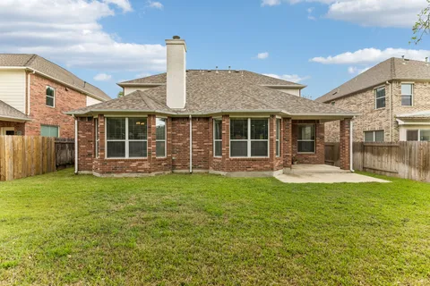 a view of a house with a yard and sitting area
