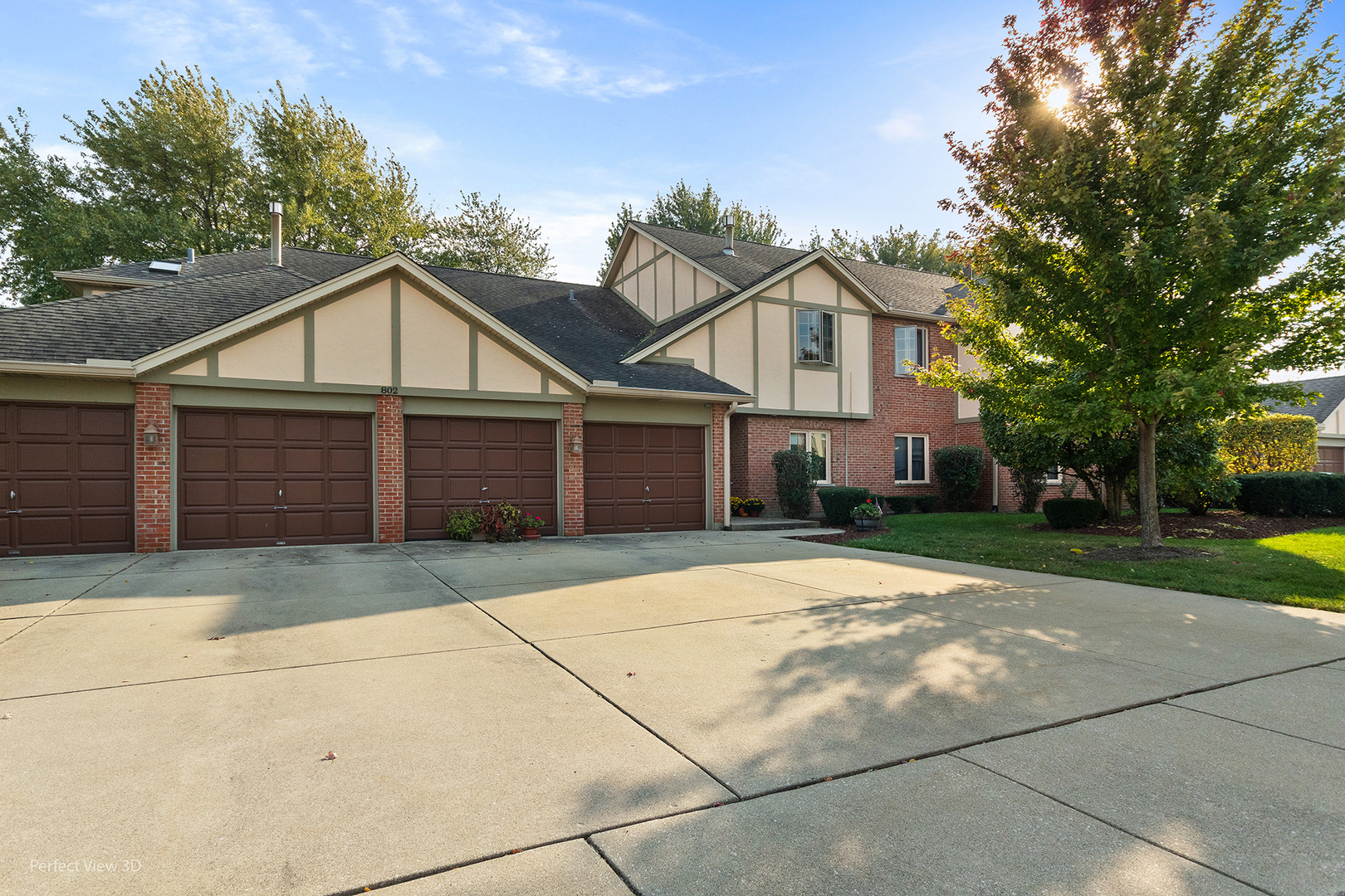 802 Meadow Ridge Lane, Unit 104 New Lenox, IL 60451 - Photo 15 of 15 a front view of a house with a garden