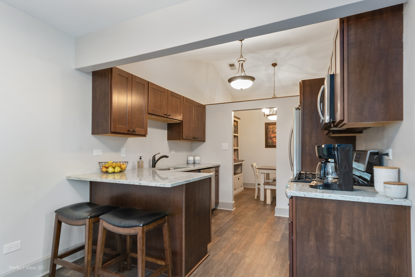 802 Meadow Ridge Lane, Unit 104 New Lenox, IL 60451 - Photo 6 of 15 a kitchen with stainless steel appliances kitchen island granite countertop a sink and cabinets