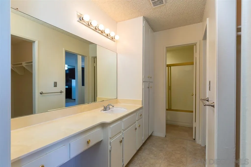 6780 Friars Road, Unit 257 San Diego, CA 92108 - Photo 13 of 20 a bathroom with a double vanity sink mirror and bathtub