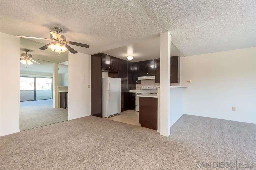 6780 Friars Road, Unit 257 San Diego, CA 92108 - Photo 3 of 20 a view of a kitchen with a sink and a refrigerator