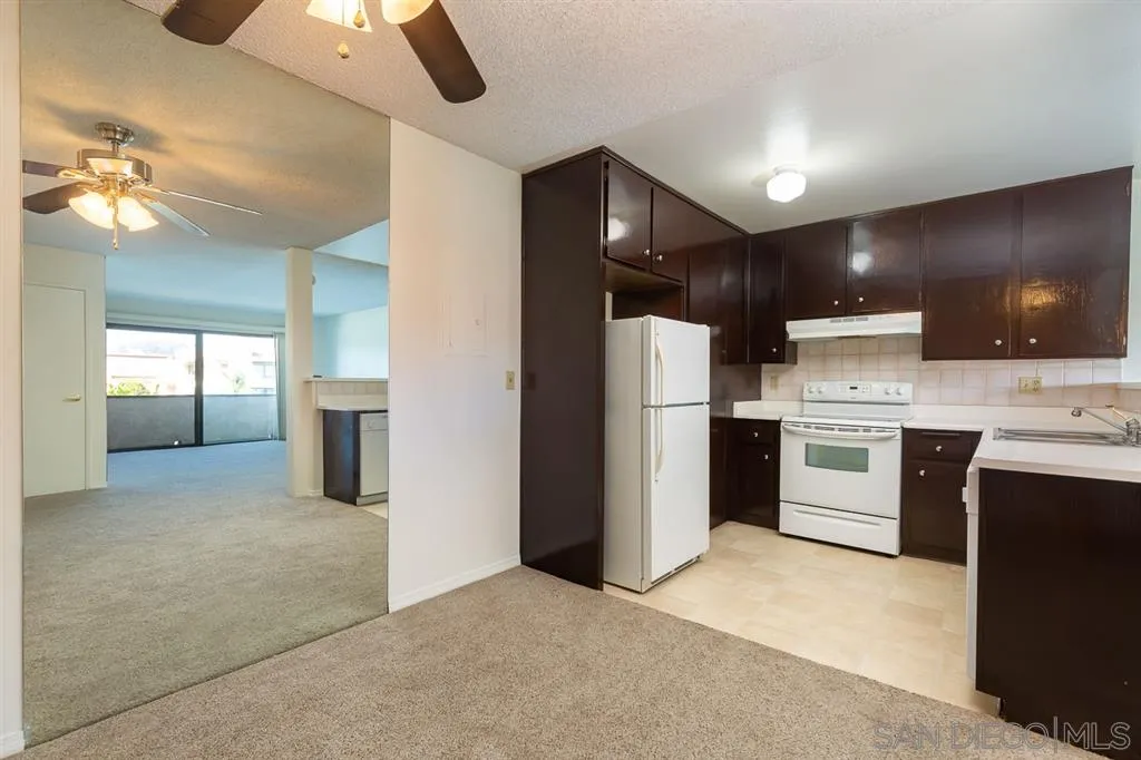 6780 Friars Road, Unit 257 San Diego, CA 92108 - Photo 4 of 20 a kitchen with refrigerator and cabinets