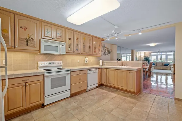 a kitchen with stainless steel appliances a refrigerator and a stove