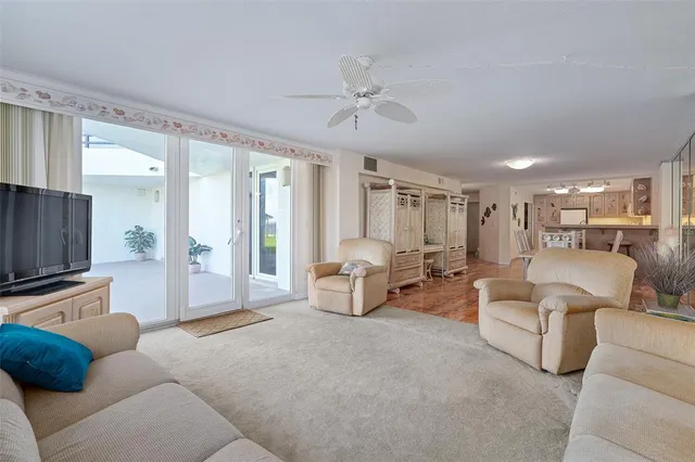 a dining room with furniture a chandelier and wooden floor
