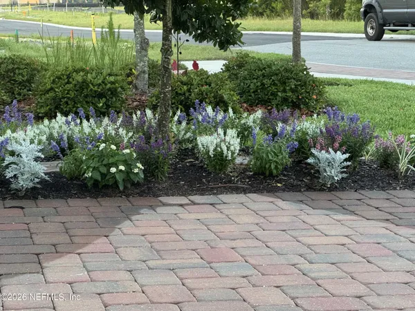 a view of outdoor space with garden and trees