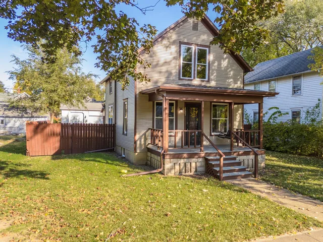 a view of a house with backyard porch and sitting area