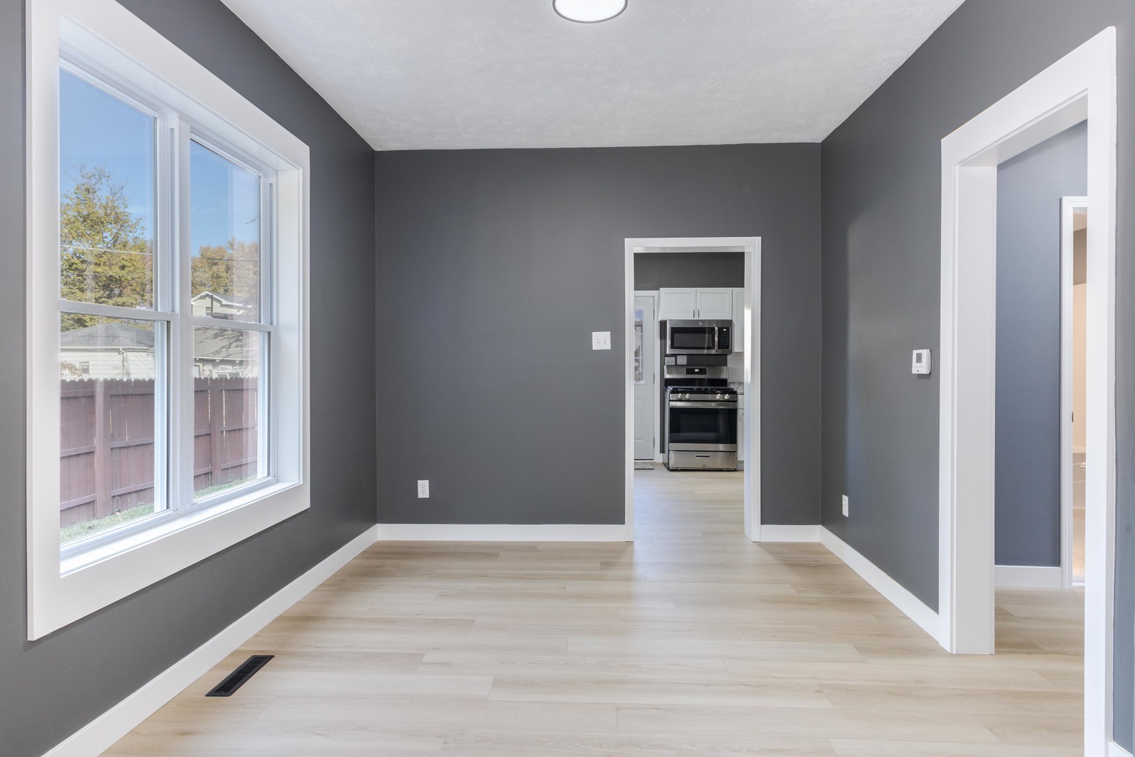 417 East Timber Street Pontiac, IL 61764 - Photo 16 of 43 a view of an empty room with wooden floor and windows
