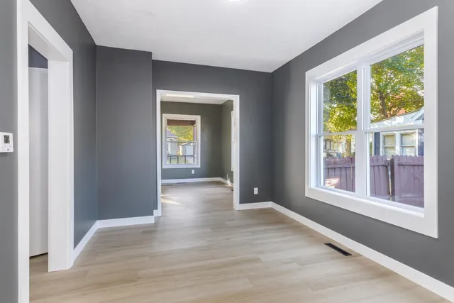 a kitchen with granite countertop white cabinets white appliances and a sink