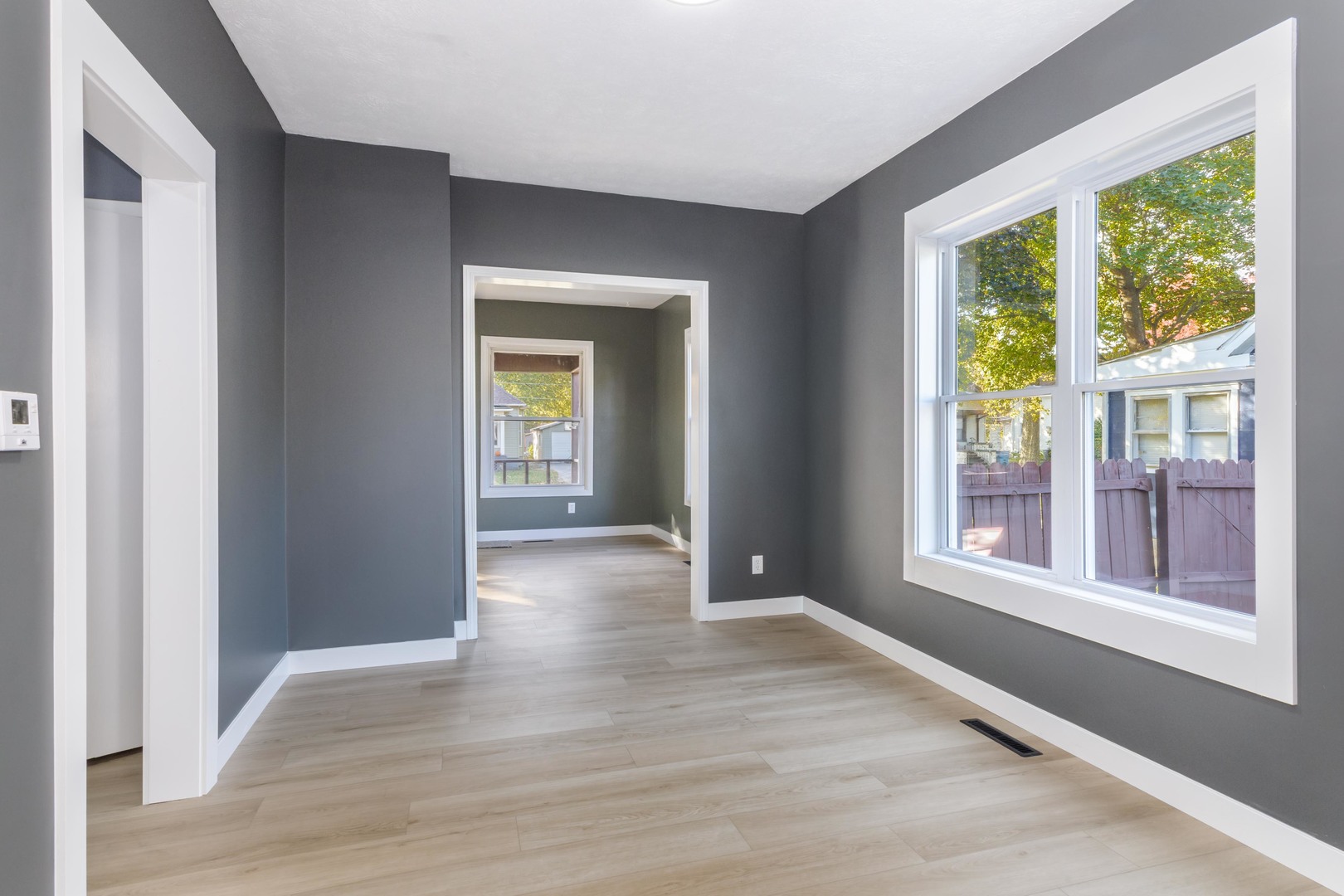 417 East Timber Street Pontiac, IL 61764 - Photo 18 of 43 a view of an empty room with wooden floor and a window