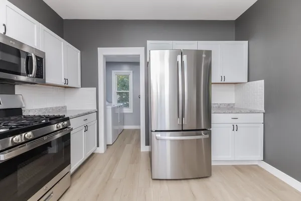 a kitchen with granite countertop a refrigerator and a sink