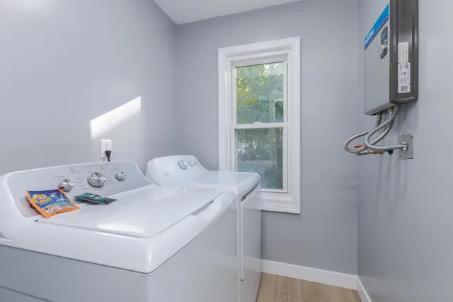 an empty room with a bathroom and a window