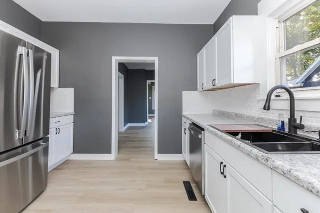a view of a hallway with wooden floor and closet