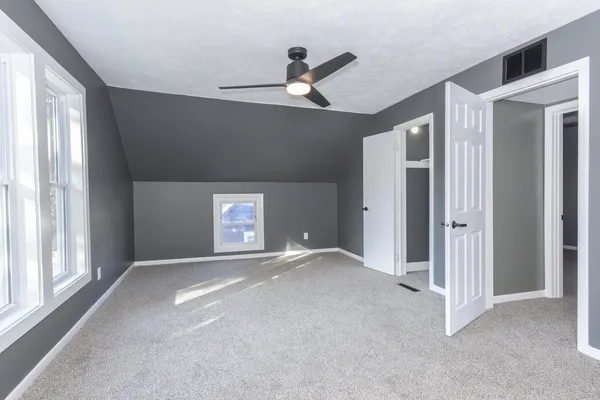 a view of an empty room with a ceiling fan
