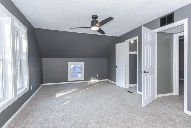 a view of an empty room with a ceiling fan