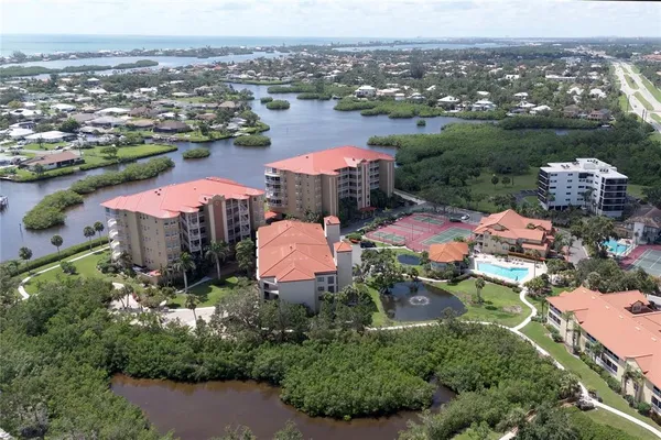 an aerial view of residential houses with outdoor space and swimming pool