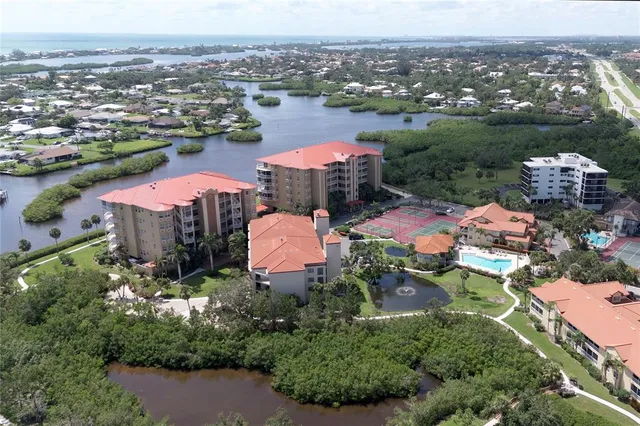 an aerial view of residential houses with outdoor space and swimming pool