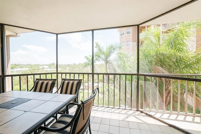 a view of a balcony with floor to ceiling windows with wooden floor