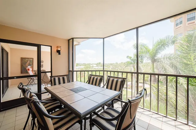 a view of a hallway with wooden floor and a bathroom