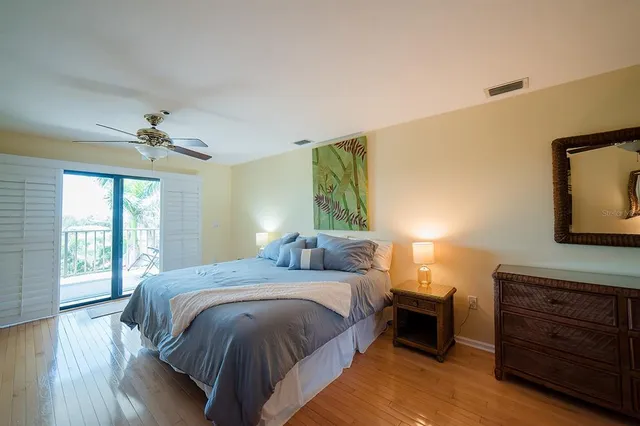 a view of a house with a yard and potted plants