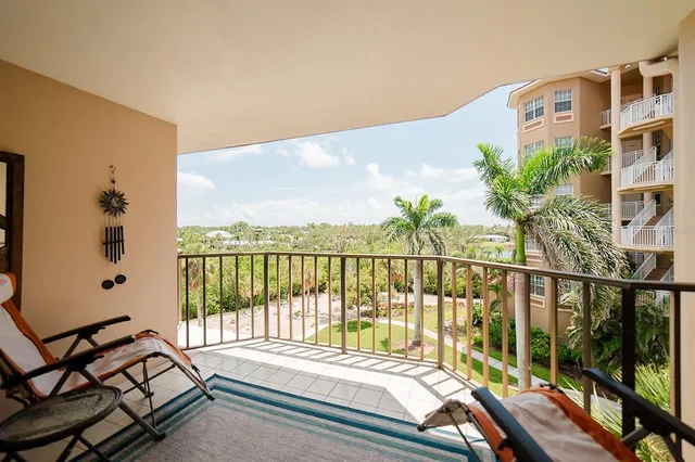 a view of a hallway with wooden floor and a bathroom