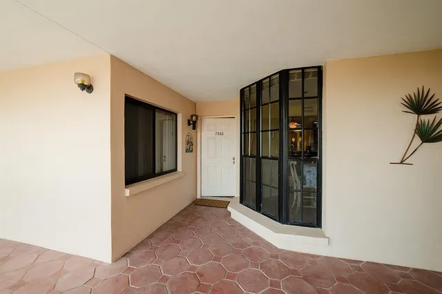 a living room with fireplace furniture and a rug