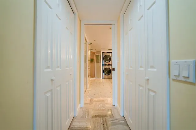 a bathroom with a granite countertop sink and a washing machine