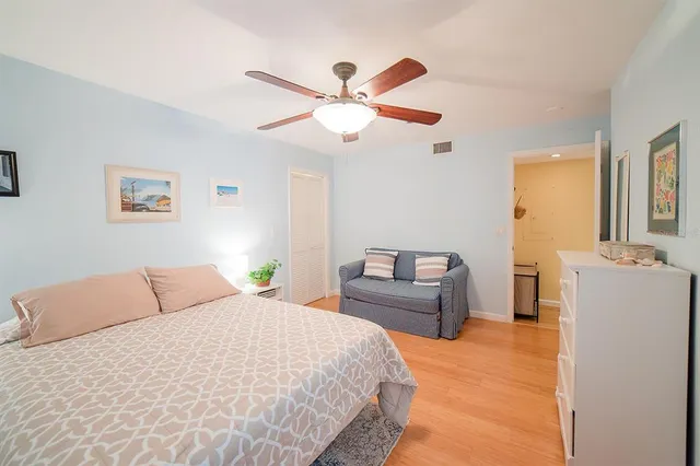 a front view of a house with a tree in a yard