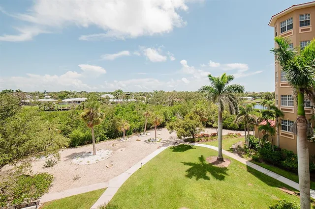 an aerial view of a house with outdoor space and lake view in back