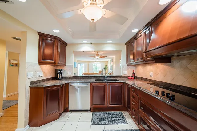 a kitchen with granite countertop stainless steel appliances and wooden cabinets
