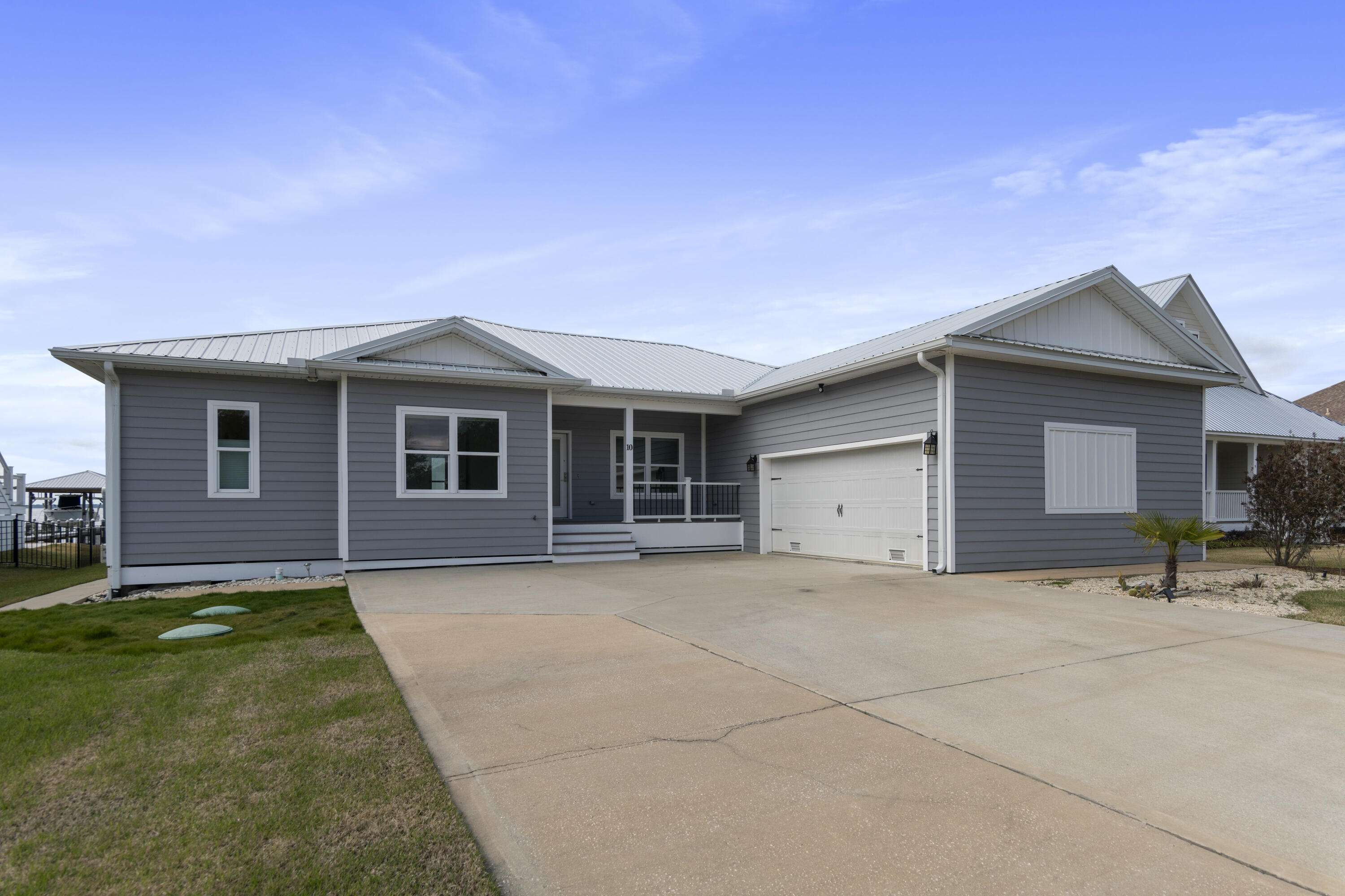 10 South Sunset Harbour Freeport, FL 32439 - Photo 12 of 57 a front view of house with yard and trees in the background