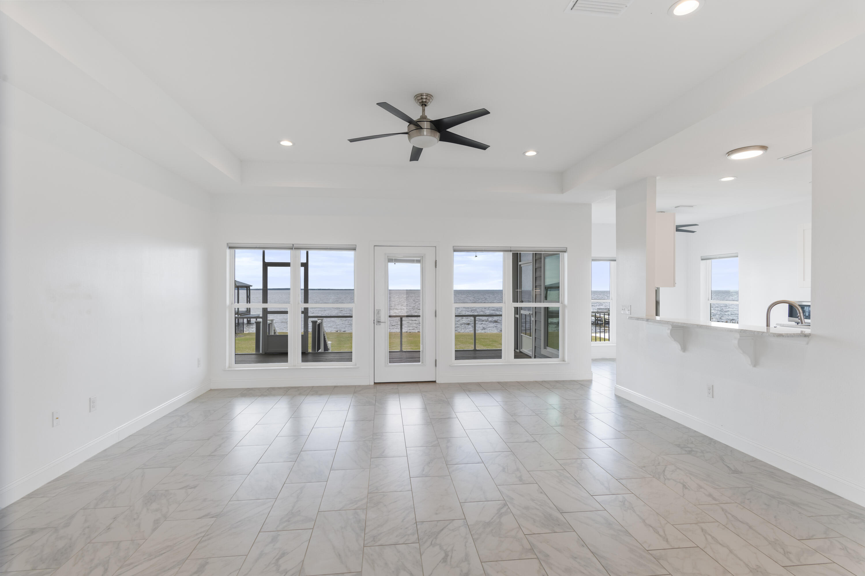 10 South Sunset Harbour Freeport, FL 32439 - Photo 14 of 57 a view of an empty room with a window and wooden floor