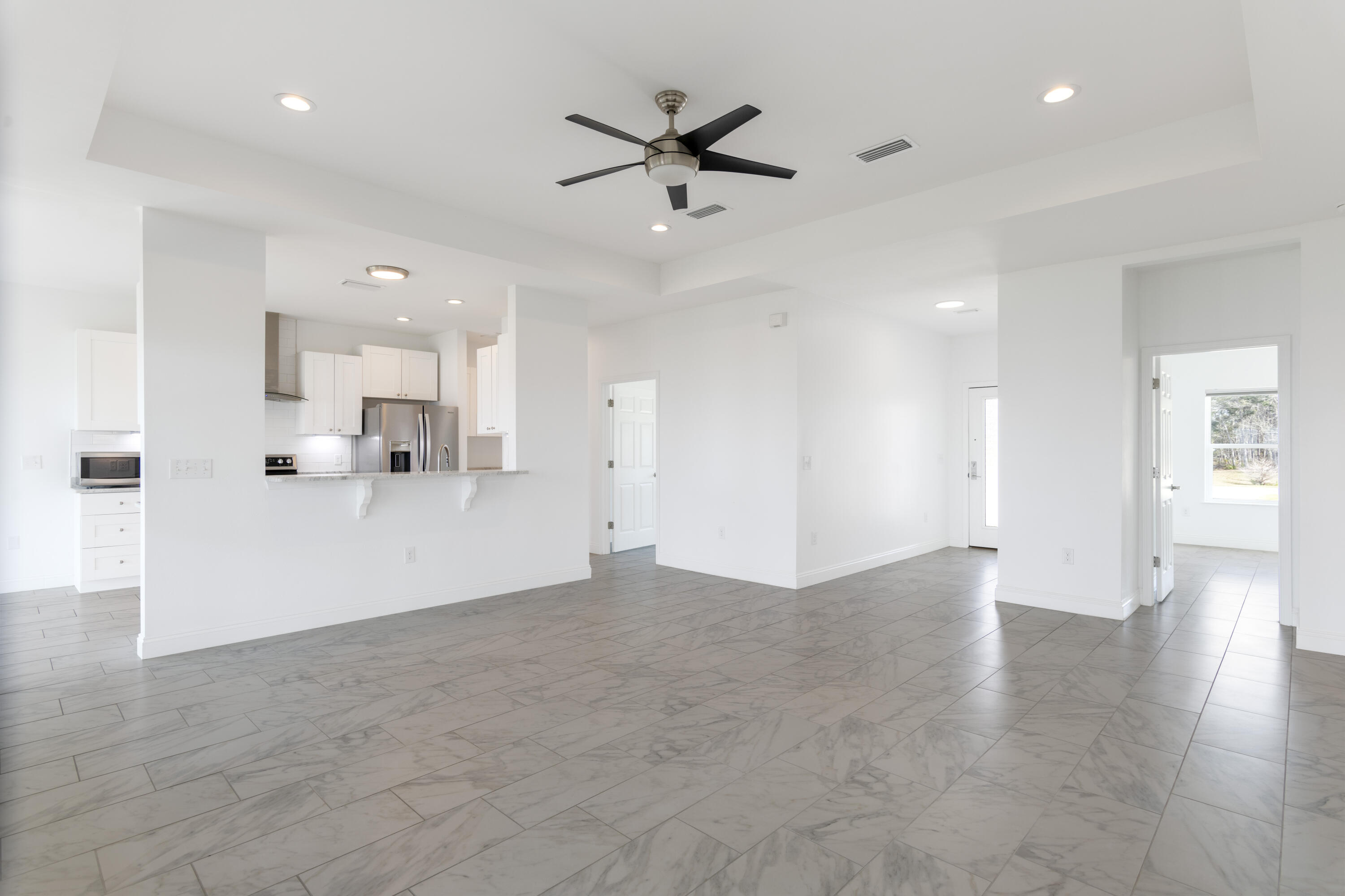 10 South Sunset Harbour Freeport, FL 32439 - Photo 18 of 57 an empty room with wooden floor and a ceiling fan