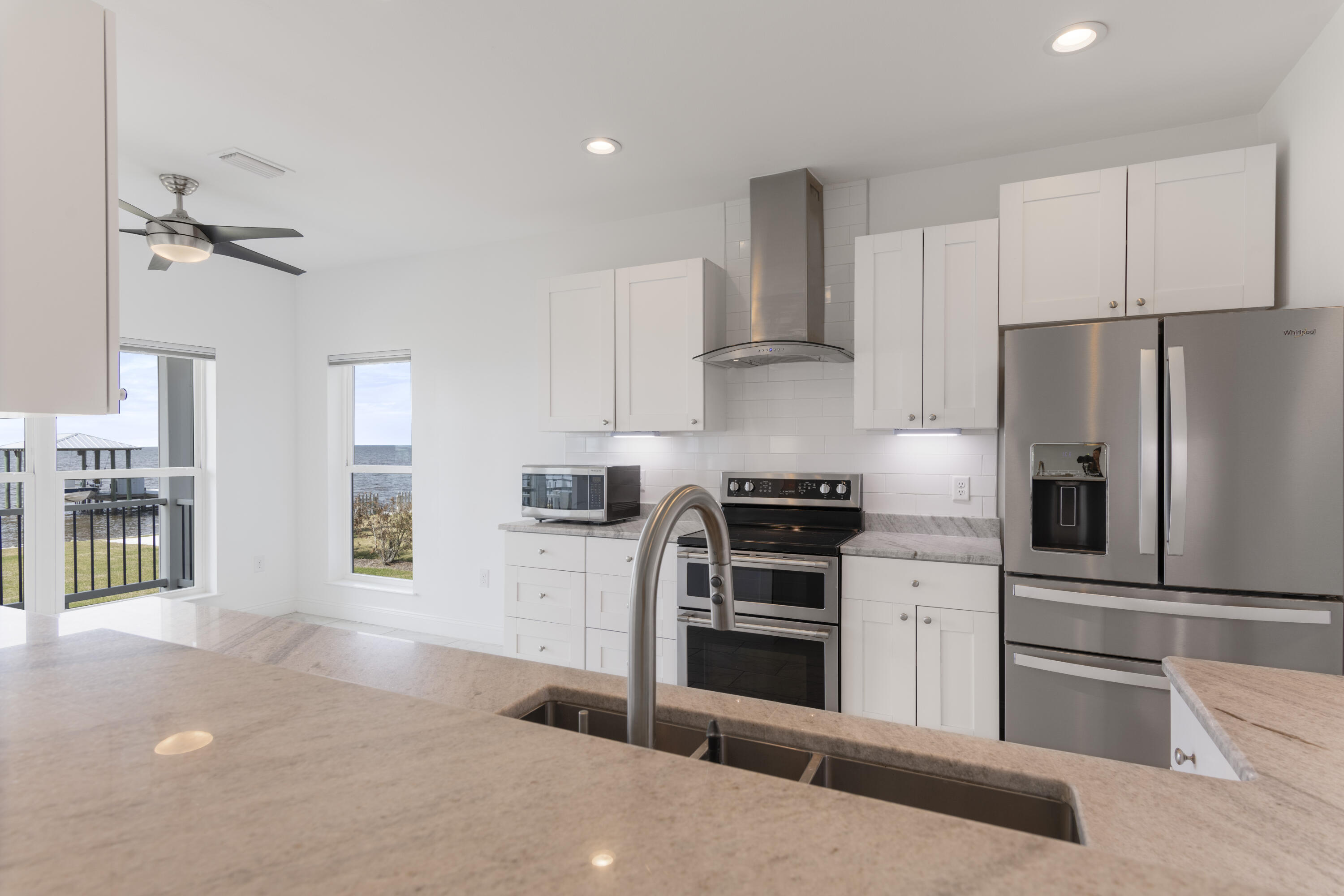 10 South Sunset Harbour Freeport, FL 32439 - Photo 19 of 57 a kitchen with stainless steel appliances and cabinets