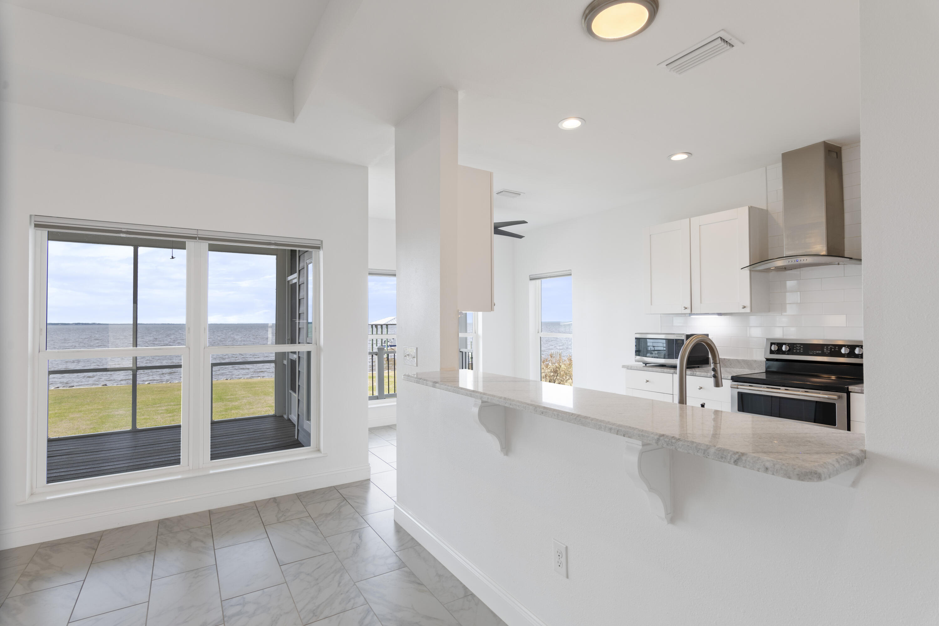 10 South Sunset Harbour Freeport, FL 32439 - Photo 20 of 57 a large kitchen with stainless steel appliances a large counter top a stove and a refrigerator