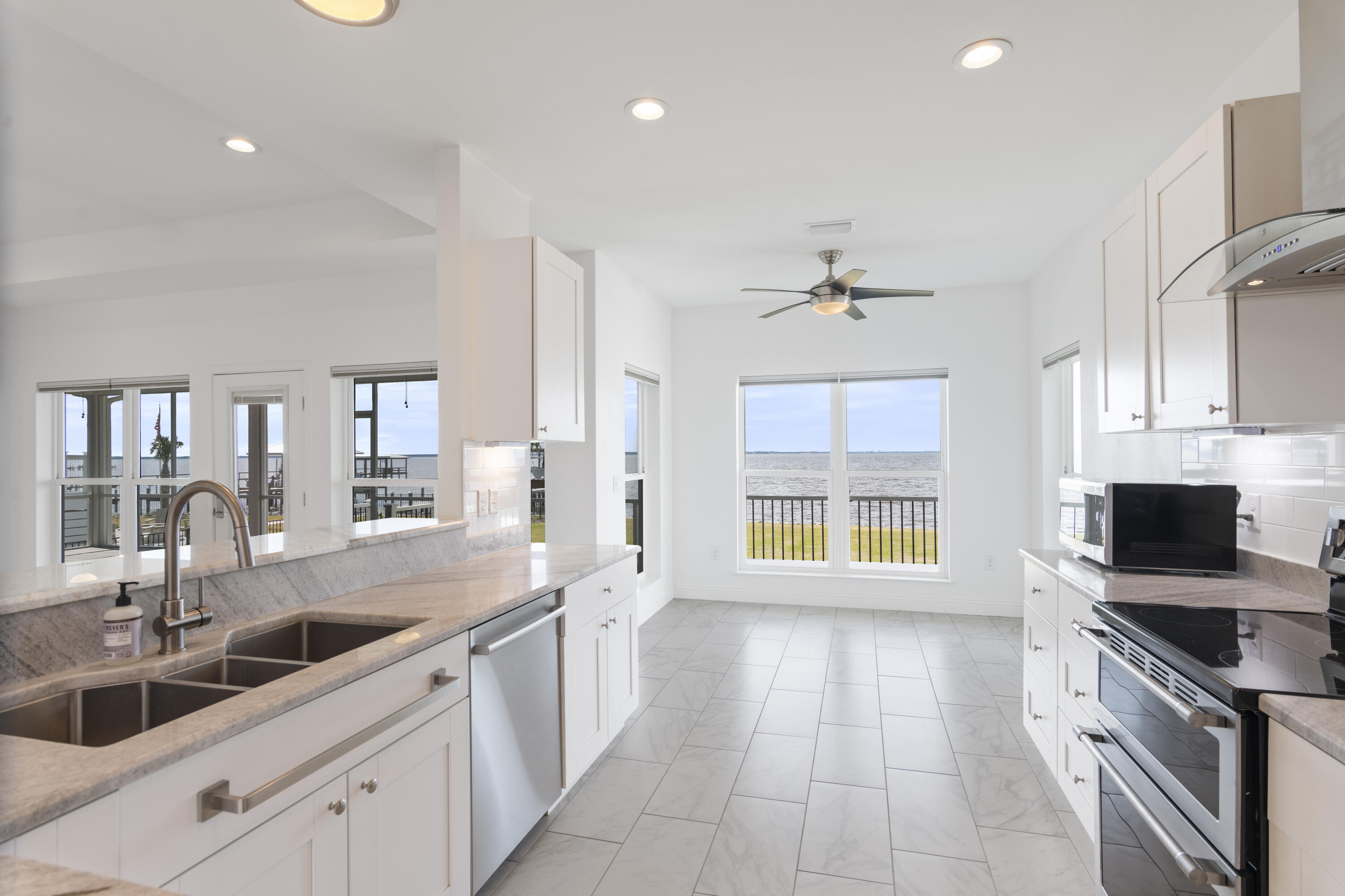 10 South Sunset Harbour Freeport, FL 32439 - Photo 21 of 57 a large kitchen with a large counter top a sink stainless steel appliances and cabinets